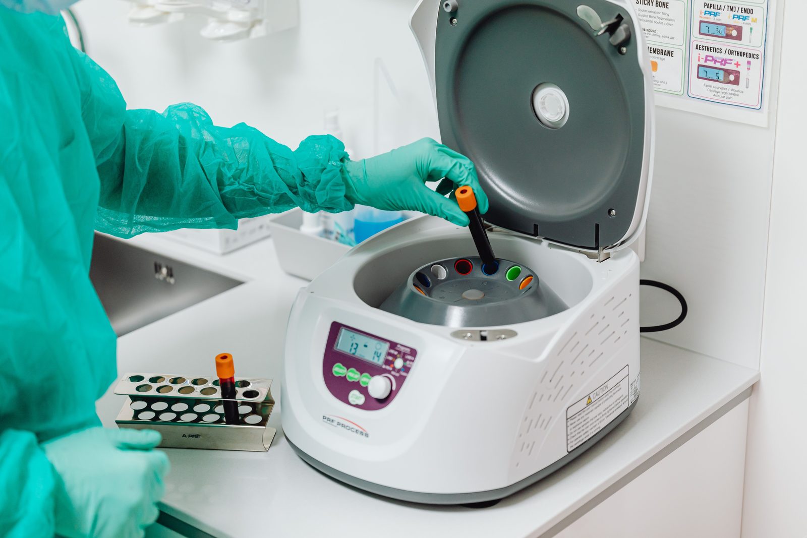 Technician loading samples into a laboratory centrifuge